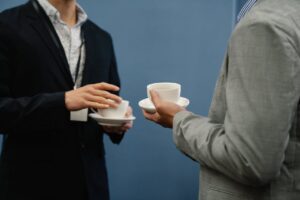 Photo of People Holding Saucers with White Cups